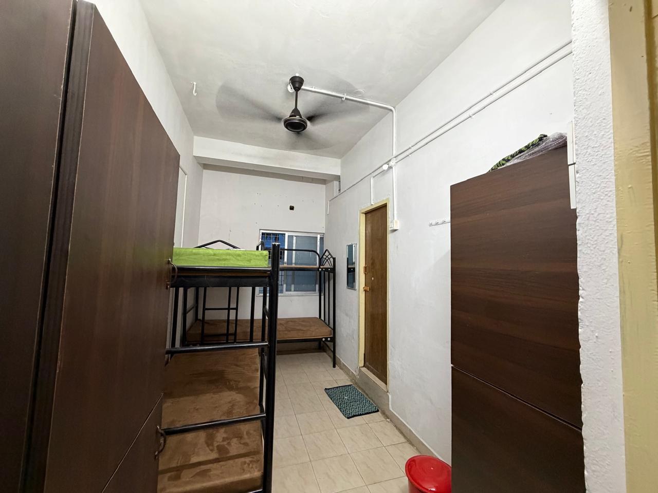 Four sharing room with bunk beds and tall wardrobes at Malarini Women's Hostel, West Mambalam