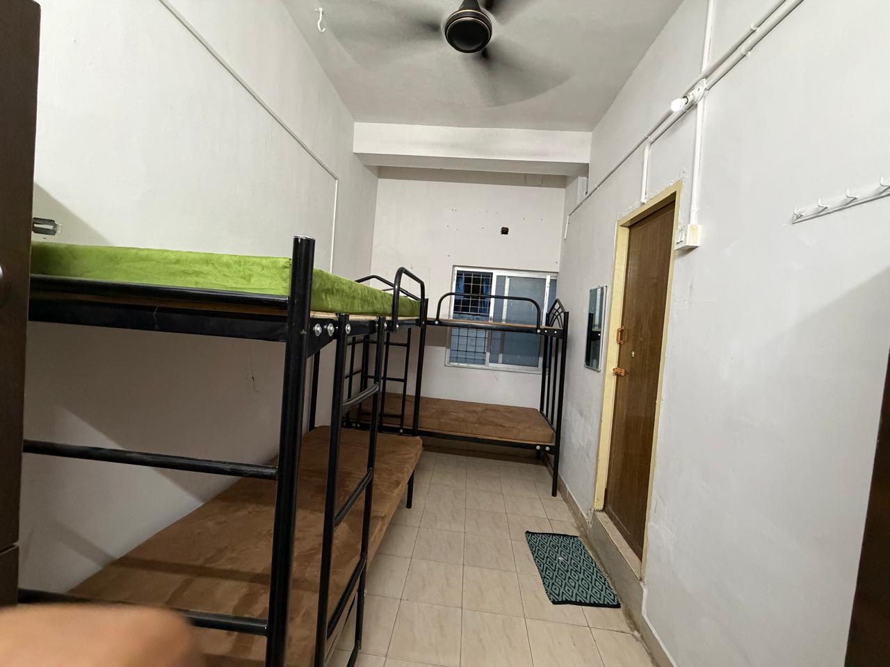 Spacious four sharing room with tiled flooring and window ventilation