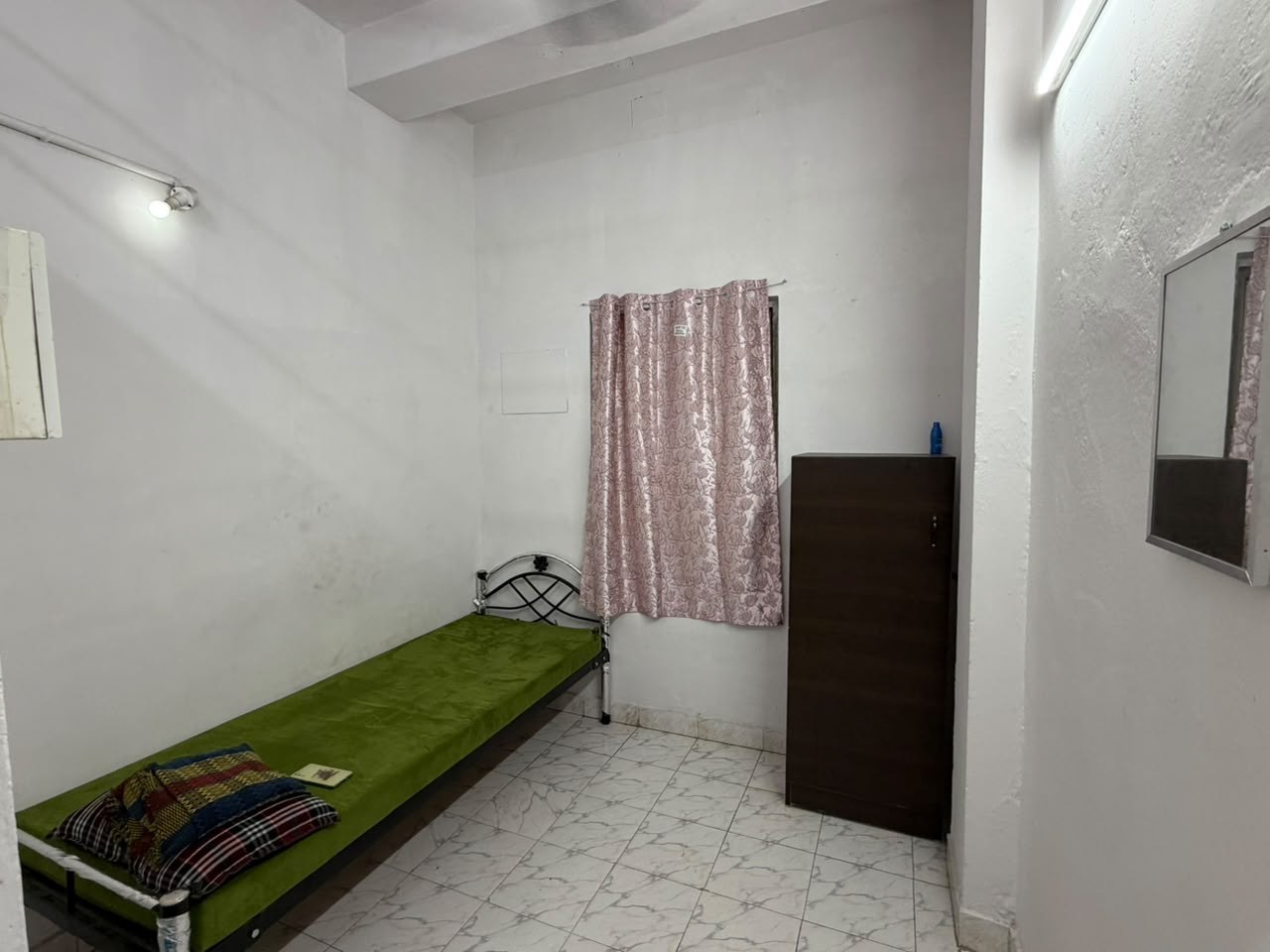 Airy single sharing room with bright lighting, tiled flooring and personal storage